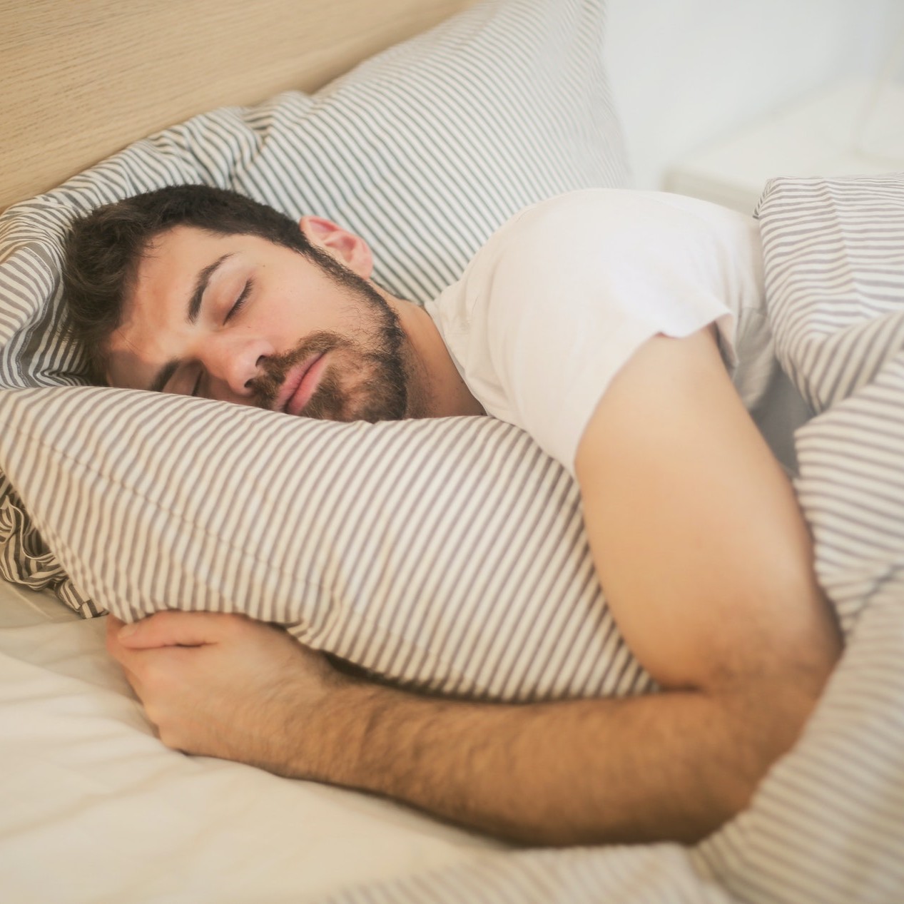 man asleep in bed