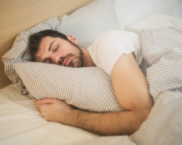 man asleep in bed