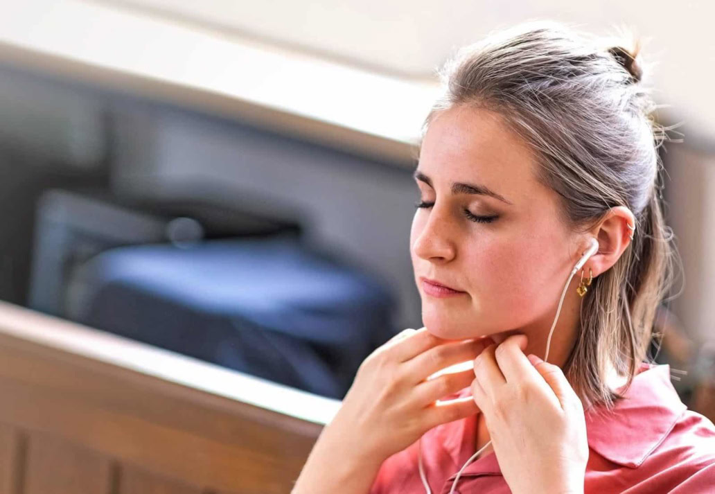 Woman practising Sophrology with earphones
