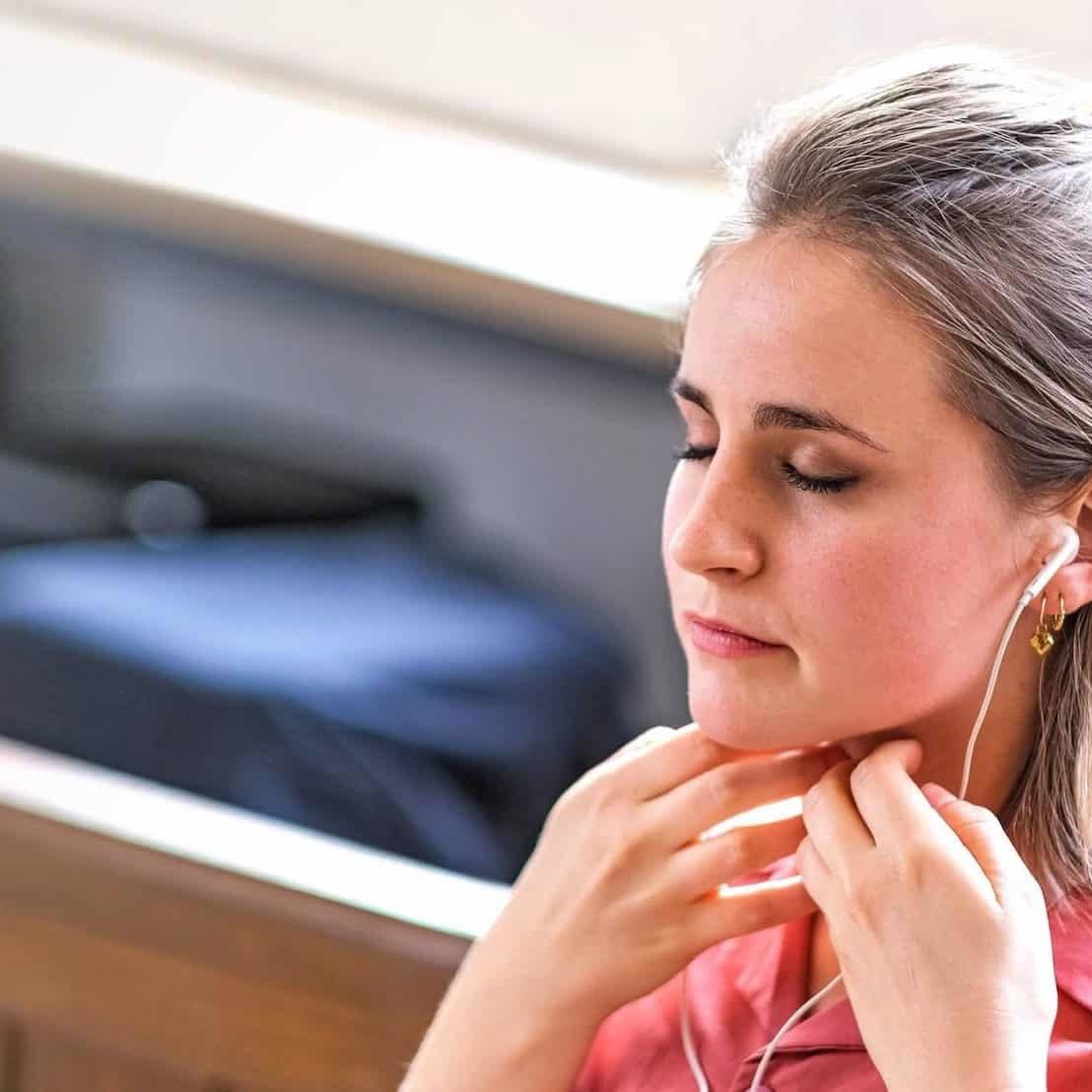 Woman practising Sophrology with earphones