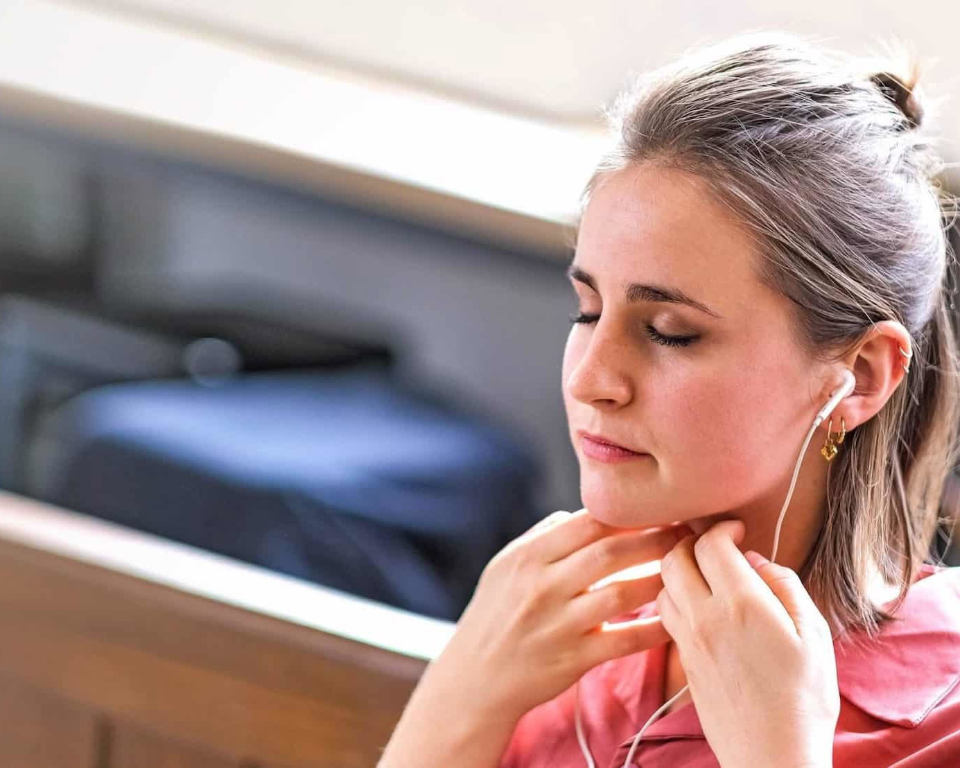 Woman practising Sophrology with earphones