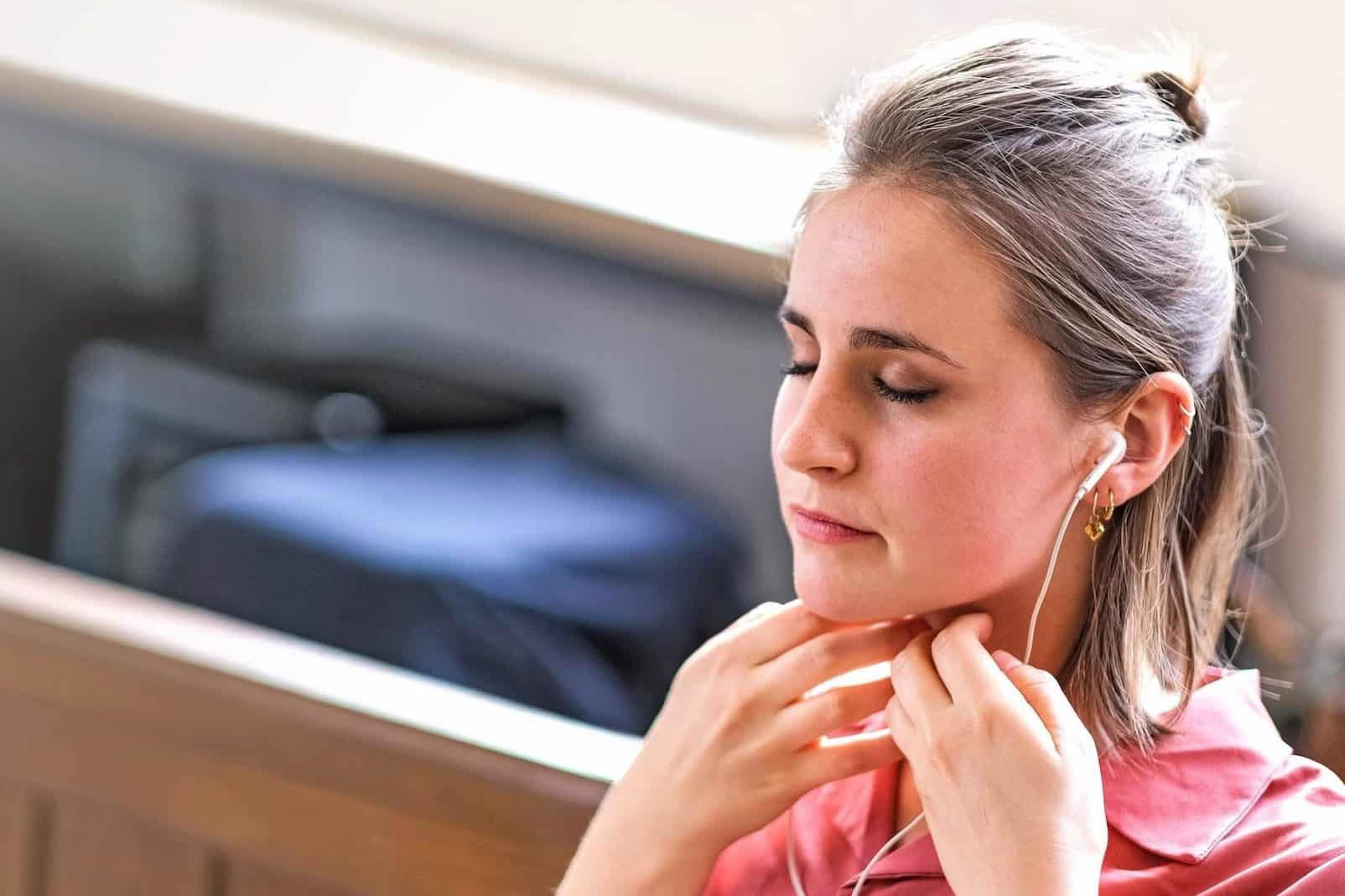 Woman practising Sophrology with earphones