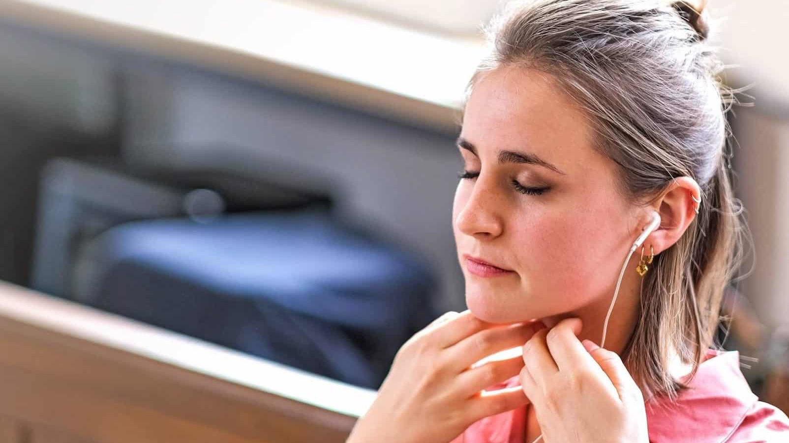 Woman practising Sophrology with earphones
