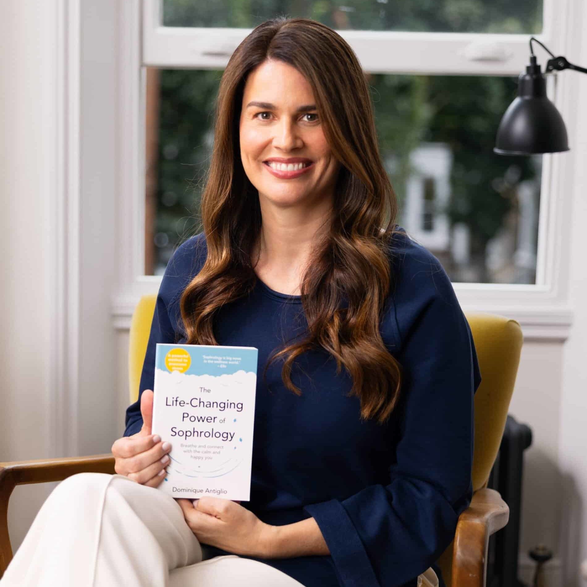 Dominique showing her book the life-changing power of sophrology