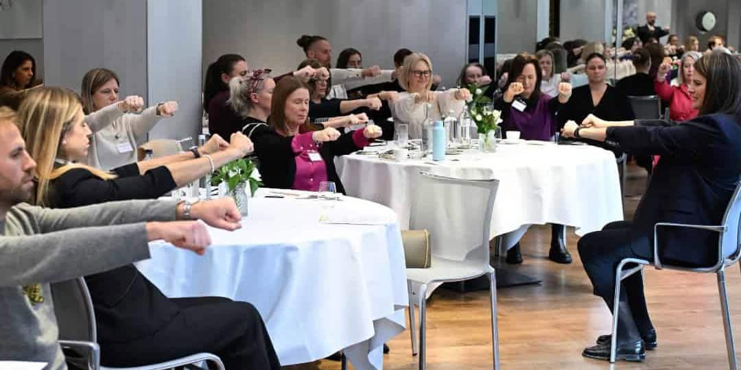 A corporate workshop with people practising Sophrology exercises