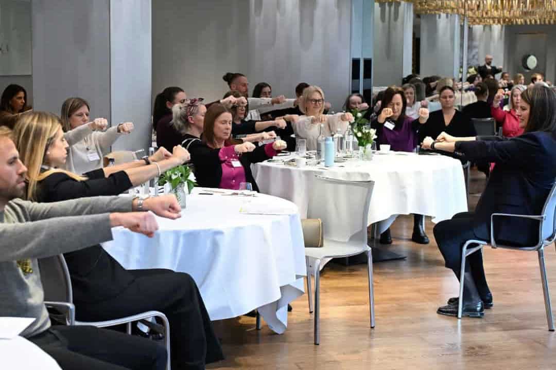 A corporate workshop with people practising Sophrology exercises